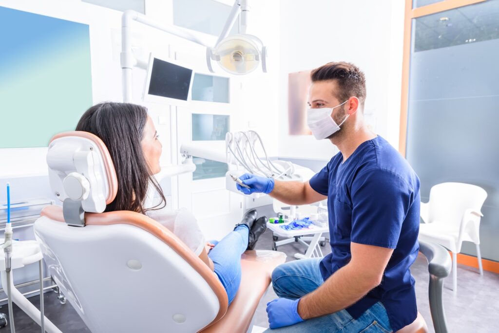 Orthodontist and patient talking in dental office