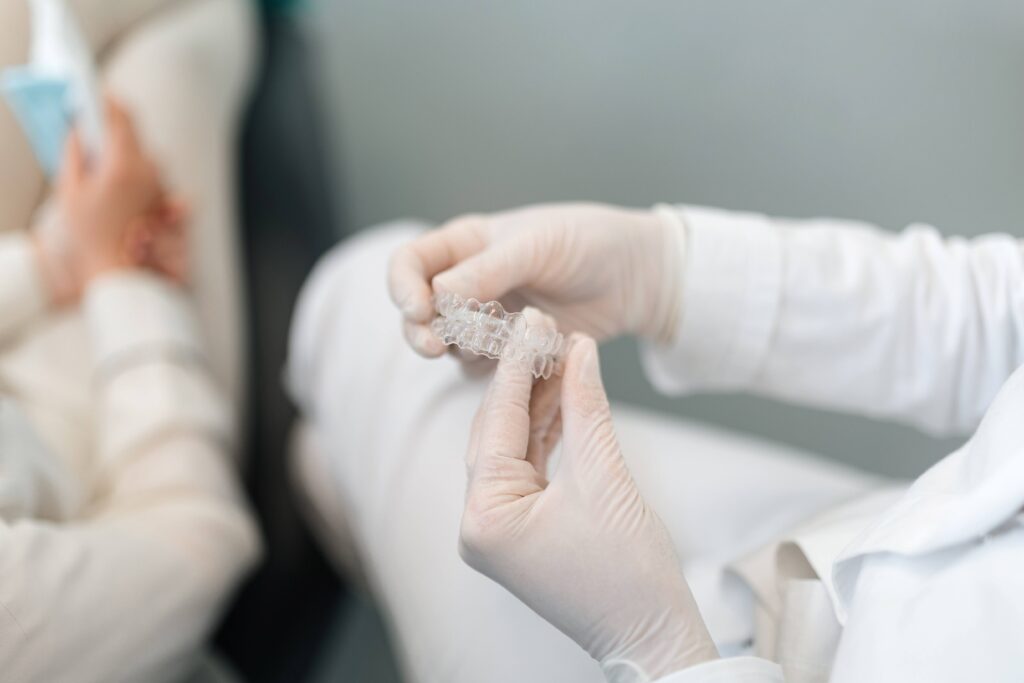 Orthodontist holding clear aligner
