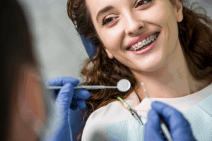 a patient with braces speaking with their orthodontist